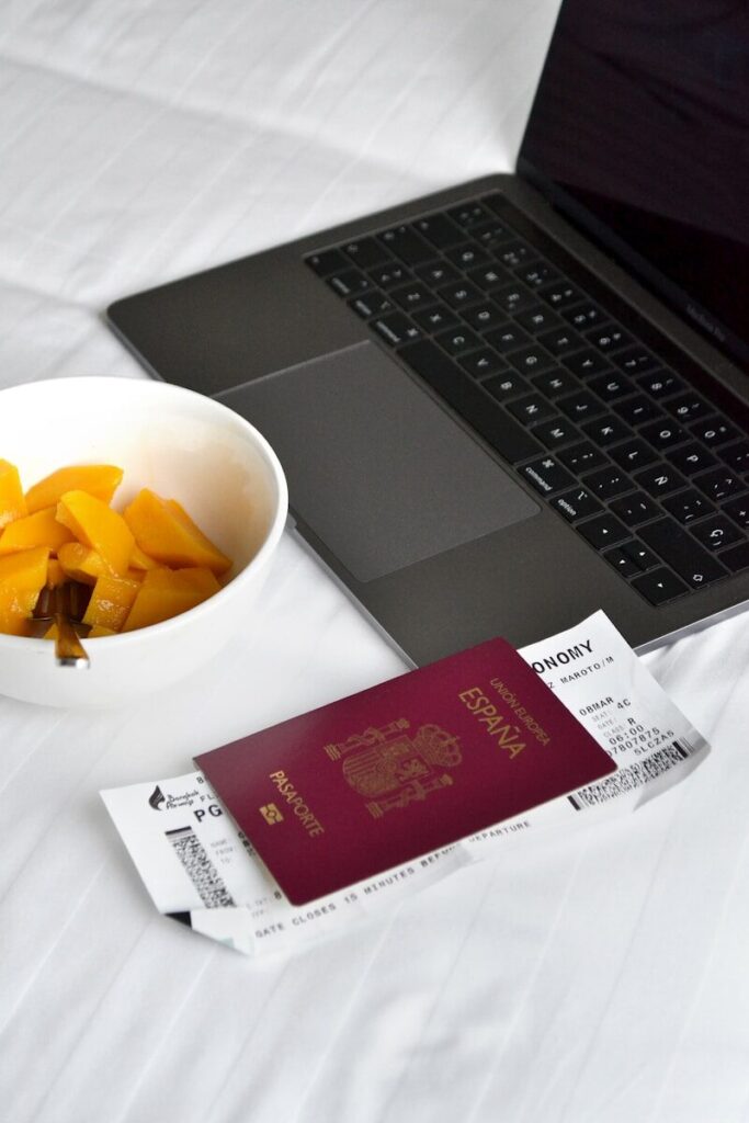 Travel essentials, passport, laptop and breakfast.